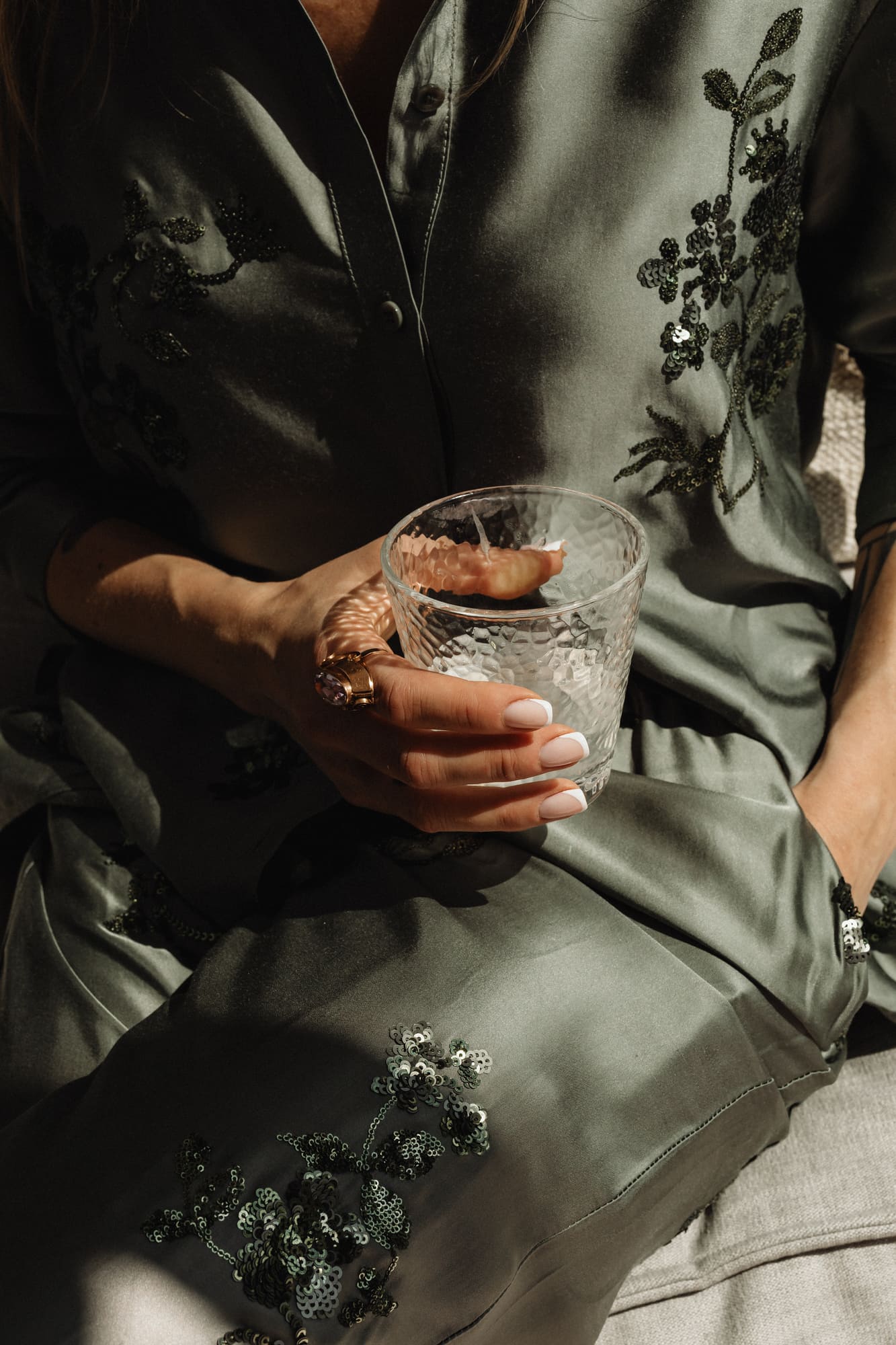 kaboompics_woman-in-satin-ensemble-with-french-manicure-holding-a-glass-of-water-32276.jpg